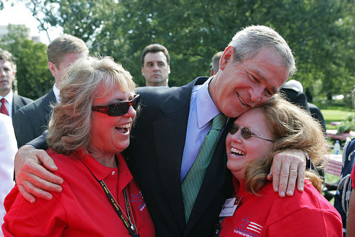 President George W. Bush hugs Theresa Luna of Oxnard, Calif., left, and Debbie Parrish of LaSalle, Colo., during an event for military support organizations Tuesday, Sept. 18, 2007, on the South Lawn. Ms. Luna's son, Pfc. Kevin Luna, died in June 2005 while serving with the U.S. Army in Iraq. Ms. Parrish's son, Pfc. Victor Parrish, is serving with the U.S. Marines in Iraq. White House photo by Chris Greenberg