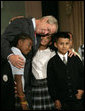 President George W. Bush hugs students from New York Public School 76 as he makes a statement to the press about No Child Left Behind Wednesday, Sept. 26, 2007, in New York. "Last week the school system here in New York City received the Broad Prize for Urban Education. This is one of the most prestigious education prizes in the country," said the President. "The award is given every year to large urban school districts that have shown the greatest overall performance and improvement in student achievement, while narrowing the achievement gap amongst poor and minority students." White House photo by Eric Draper
