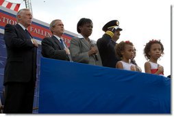 President Bush is accompanied in the Pledge of Allegiance by U.S. Senator Steny Hoyer, (D-Md.), (left), and the wife and children of firefighter Russell Schwantes of Fayetteville, Ga., during a ceremony at the National Fallen Firefighters Memorial service in Emmitsburg, Md., Sunday, Oct. 7, 2007. White House photo by Chris Greenberg