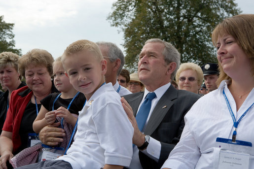 President George Bush holds 8-year-old Turner Koyle of Holden, Utah, during a ceremony at the National Fallen Firefighters Memorial in Emmitsburg, Md., Sunday, Oct. 7, 2007. White House photo by Chris Greenberg