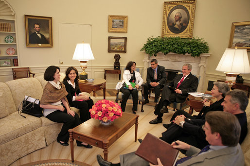 President George W. Bush meets with Yamile Llanes Labrada and her daughter Shirln Garcia, pictured sitting immediately to her mother's right, Wednesday, Oct. 10, 2007, in the Oval Office. Mrs. Labrada is the wife of Cuban political prisoner Dr. Jose Luis Garcia Paneque. White House photo by Eric Draper
