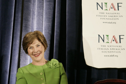 Mrs. Laura Bush smiles as she listens to an introduction by Dr. Ken Ciongoli , chairman of The National Italian American Foundation, during an education luncheon honoring Mrs. Bush with the NIAF Special Achievement Award in Literacy, Friday, Oct. 12, 2007 in Washington, D.C. In thanking the organization Mrs. Bush emphasized the many contributions that Italian-Americans have made in the education of our nation’s youth. White House photo by Shealah Craighead