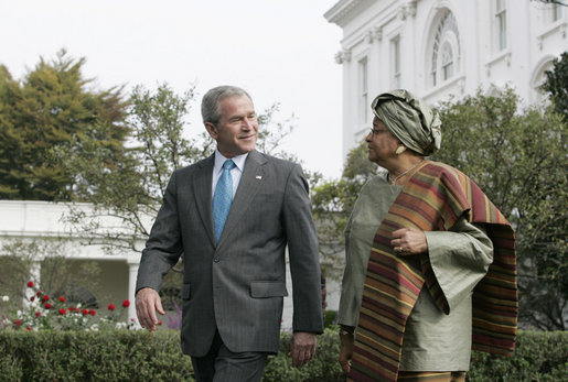 President George W. Bush speaks with President Ellen Johnson Sirleaf of the Republic of Liberia during a walk along the South Lawn driveway, Thursday, Oct. 18, 2007. White House photo by Joyce N. Boghosian