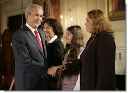 President George W. Bush greets his guests Marlenis Gonzalez, right, and her daughter Melissa, center, Wednesday, October 24, 2007, after his remarks on Cuba policy at the State Department in Washington, D.C. Melissa's father, Jorge Luis Gonzalez Tanquero is currently being held in a Cuban prison after being arrested for crimes against the regime. White House photo by Eric Draper