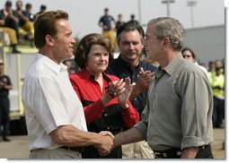 President George W. Bush shakes hands with California Governor Arnold Schwarzenegger as he talks with the media after touring the Rancho Bernardo neighborhood Thursday, Oct. 25, 2007, with Senator Dianne Feinstein, D-Calif., and FEMA Director David Paulison. Said the President: "To the extent that people need help from the federal government, we will help. My job is to make sure that FEMA and the Defense Department and the Interior Department and Ag Department respond in a way that helps people get the job done." White House photo by Eric Draper