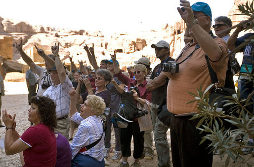A group of tourists from Texas wave to Mrs. Laura Bush while touring Petra Friday, Oct. 26, 2007, in southern Jordan. Last year more than 300,000 visitors from around the world toured the ancient ruins. White House photo by Shealah Craighead
