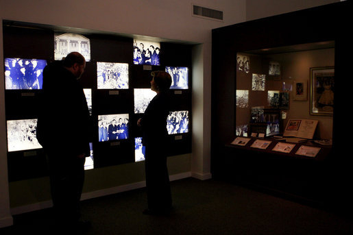 Mrs. Laura Bush, joined by Russell Caldwell, manager of visitor services at the Margaret Mitchell House and Museum in Atlanta, Ga., looks at a photo display showing images from the 1939 movie premiere of Gone with the Wind, during a tour of the famous author’s home, Thursday, Nov. 1, 2007. White House photo by Shealah Craighead