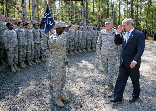 President George W. Bush salutes as he acknowledges members of the 260th Brigade during his visit to Fort Jackson in Columbia, S.C. Fort Jackson is the largest and most active Initial Entry Training Center in the U.S. Army, training more than 50 percent of all soldiers enter the Army each year. With him is Brig. Gen James Schwitter, Commanding General of the base. White House photo by Eric Draper