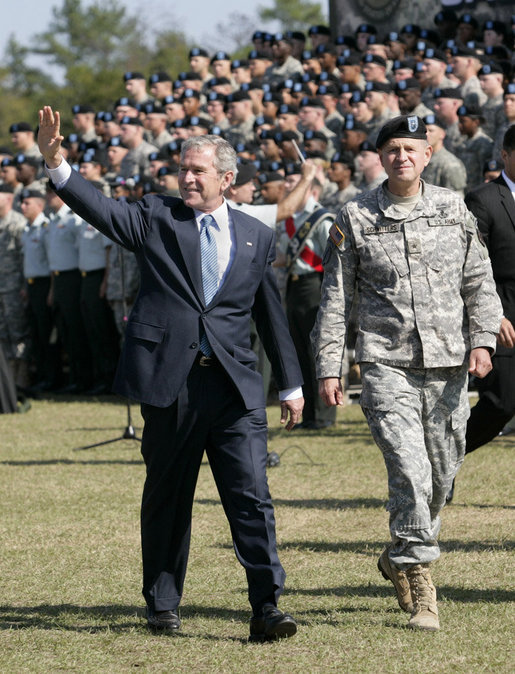 President George W. Bush waves as he and Brigadier General James Schwitters, Commanding General at Fort Jackson, S.C., walk before the graduates Friday, Nov. 2, 2007, during the President's appearance at the Basic Combat Training Graduation Ceremony. White House photo by Eric Draper