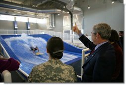 President George W. Bush gives the thumbs up during a Flowrider demonstration, Thursday, Nov. 8, 2007 at the Center for The Intrepid at the Brooke Army Medical Center in San Antonio, Texas. Wounded soldiers use the wave simulation activity to improve balance, coordination and strength. White House photo by Eric Draper