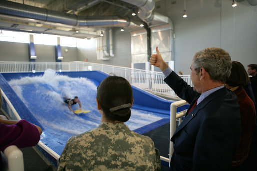 President George W. Bush gives the thumbs up during a Flowrider demonstration, Thursday, Nov. 8, 2007 at the Center for The Intrepid at the Brooke Army Medical Center in San Antonio, Texas. Wounded soldiers use the wave simulation activity to improve balance, coordination and strength. White House photo by Eric Draper