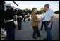President George W. Bush and Mrs. Laura Bush welcome German Chancellor Angela Merkel and her husband Dr. Joachim Sauer as they arrive via helicopter to the Bush ranch in Crawford, Texas, Friday, Nov. 9, 2007. White House photo by Eric Draper