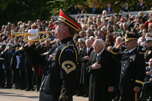 An U.S. Army Band bugler plays Taps during a wreath-laying ceremony at the Tomb of the Unknown Soldier, Sunday, Nov. 11, 2007, at Arlington National Cemetery in Arlington, Va. White House photo by David Bohrer