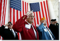 Veteran Warren G. King, Sr. of Nashville, center, salutes with fellow veterans Sunday, Nov. 11, 2007, during Veterans Day ceremonies at Arlington National Cemetery in Arlington, Va. White House photo by David Bohrer