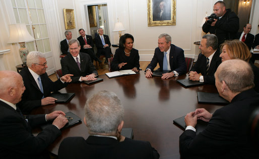 President George W. Bush shares a light moment with Palestinian President Mahmoud Abbas, second from left, Israel's Prime Minister Ehud Olmert, lower right during a meeting Tuesday, Nov. 27, 2007, during the Annapolis Conference in Annapolis, Maryland. With them are senior officials from Israel, Palestine and the United States, including National Security Adviser Stephen Hadley, third from left, and United States Secretary of State Condoleezza Rice. White House photo by Chris Greenberg