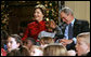President George W. Bush and Mrs. Laura Bush share a moment with Malik Lawson during the Children's Holiday Performance Monday, Dec. 3, 2007, at the White House. The 7-year-old is the son of Sgt. Sherry Martin, currently serving in Iraq. White House photo by Joyce N. Boghosian