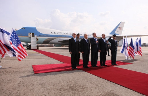 President George W. Bush is joined on the red carpet by Israel’s Prime Minister Ehud Olmert, right, President Shimon Peres, second from left, and Ambassador Yitzhak Eldan, Israel’s Chief of Protocol, after arriving Wednesday, Jan. 9, 2008, in Tel Aviv for the first stop of his Mideast visit. White House photo by Eric Draper