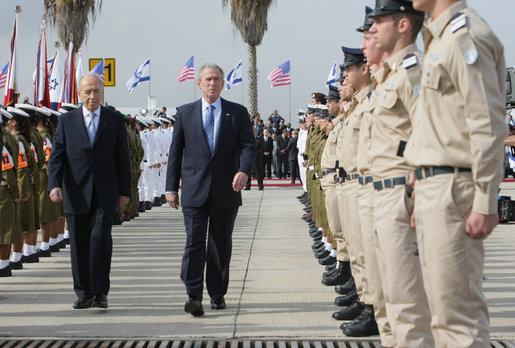 President George W. Bush and Israel’s Shimon Peres review the troops during an arrival ceremony Wednesday, Jan. 9, 2008, at Ben Gurion International Airport. President Bush arrived in Tel Aviv on the first stop of his eight-day, Mideast visit. White House photo by Eric Draper