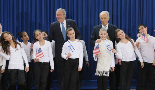 President George W. Bush poses with President Shimon Peres of Israel and 10 children who performed during their meeting Wednesday, Jan. 9, 2008, at the President Peres’ residence in Jerusalem. White House photo by Eric Draper
