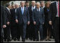 President George W. Bush walks with Israel's President Shimon Peres, right, and Prime Minister Ehud Olmert, center, as they arrive Friday, Jan. 11, 2008, to Yad Vashem, the Holocaust Museum, in Jerusalem, where the President laid a wreath in honor of Holocaust victims before departing Jerusalem for Galilee. White House photo by Eric Draper