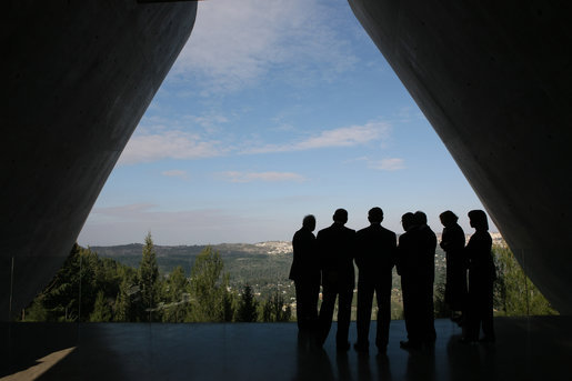President George W. Bush, center, is silhouetted as he views Jerusalem from Yad Vashem, the Holocaust Museum, Friday, Jan. 11, 2008. The President was joined by Secretary of State Condoleezza Rice, right, Israel's Prime Minister Ehud Olmert, second from left, and Israel's President Shimon Peres during the visit. White House photo by Eric Draper