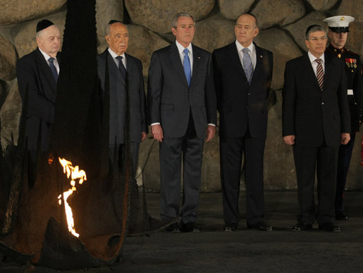 President George W. Bush pauses to pay respects in the Hall of Remembrance Friday, Jan. 11, 2008, at Yad Vashem, the Holocaust Museum in Jerusalem. With him, from left, are: Josef Lapid, Chairman of the Yad Vashem Council; Israel’s President Shimon Peres, Israel’s Prime Minister Ehud Olmert, and Avner Shalev, Chairman of the Yad Vashem Directorate. White House photo by Eric Draper