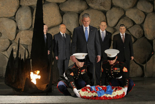 President George W. Bush bows his head as Marines lay a wreath on behalf of the United States of America, honoring the victims of the Holocaust, during a visit Friday, Jan. 11, 2008, to Yad Vashem, the Holocaust Museum in Jerusalem. White House photo by Eric Draper