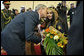 President George W. Bush gives a kiss on the cheek to a young girl Friday, Jan. 11, 2008, after she presented him with flowers upon his arrival at Kuwait International Airport in Kuwait City. White House photo by Eric Draper