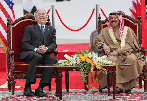 President George W. Bush and King Hamad Bin Isa Al-Khalifa break out in laughter as they sit on stage for the arrival ceremonies welcoming President Bush to Bahrain Saturday, Jan. 12, 2008, in Manama. White House photo by Eric Draper