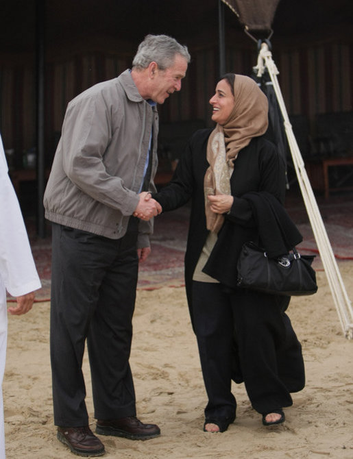 President George W. Bush shares a moment with Sheikha Lubna Khalid Al Qasimi, United Arab Emirates Minister of Economy and Planning, during dinner Sunday, Jan. 13, 2008, in the desert near Abu Dhabi. White House photo by Eric Draper