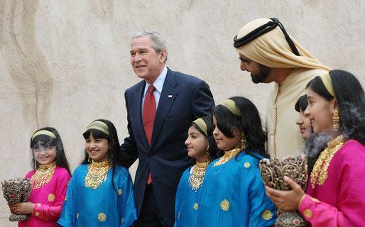 President George W. Bush and Sheikh Mohammed Bin Rashid al-Maktoum, Vice President and Prime Minister of the United Arab Emirates, pose for photos with a children’s dance group welcoming President Bush, Monday, Jan. 14, 2008, during a visit to Sheikh Saeed Al Maktoum House in Dubai. White House photo by Eric Draper