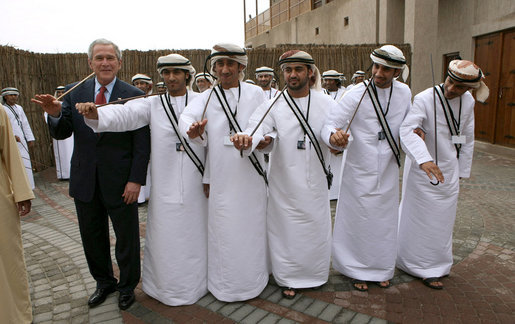 President George W. Bush poses with a group of traditional dancers, Monday, Jan. 14, 2008, during a visit to the Sheikh Saeed Maktoum House, home of Vice President and Prime Minister of the United Arab Emirates Sheikh Mohammed bin Rashid al-Maktoum, in Dubai. White House photo by Eric Draper