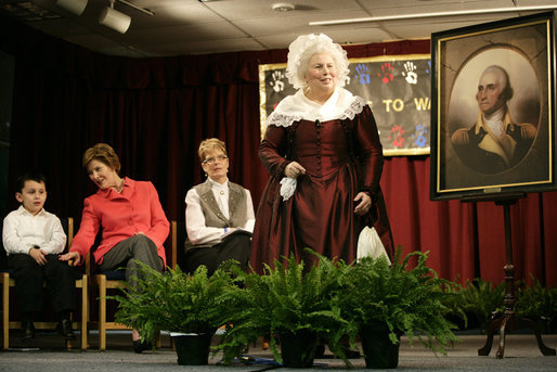 Ms. Mary Wiseman, Martha Washington Re-enactor, Mount Vernon Estate and Gardens, leads Mrs. Laura Bush, Santiago Echeverria, Student, and Dr. Tish Howard, Principal, Washington Mill Elementary School, in a ceremony at Washington Mill Elementary School Tuesday, January 15, 2008, in Alexandria, Virginia, to celebrate Mount Vernon's "George Washington's Return to School" program. The “Portrait of Leadership” initiative was planned to coincide with the 275th birthday year of George Washington, celebrated in February of 2007, to help put a portrait of George Washington in class rooms in all fifty states. White House photo by Shealah Craighead