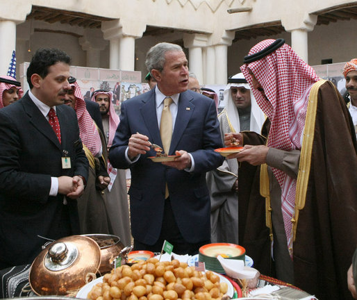 President George W. Bush and Prince Salman bin Abdul Al-Aziz, right, taste a vendor's offering Tuesday, Jan. 15, 2008, as they visited Al Murabba Palace and National History Museum in Riyadh. White House photo by Eric Draper