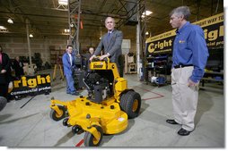 As Bill Wright, Founder and Chief Executive Officer of Wright Manufacturing, Inc., looks on, President George W. Bush stands on a "Stander" lawn mower in its final testing stage Friday, Jan. 18, 2008, during his visit to the Frederick, Maryland facility. Said the President during the visit, "Let me tell you why I'm here. This man started his own business. He's a manufacturer, he employs over a hundred people, and he represents the backbone of the American economy. And today I talked about our economy, and the fundamentals are strong, but there's uncertainty. And there's an opportunity to work with Congress to pass a pro-growth package that will deal with the uncertainty." White House photo by Joyce N. Boghosian