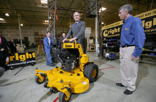 As Bill Wright, Founder and Chief Executive Officer of Wright Manufacturing, Inc., looks on, President George W. Bush stands on a "Stander" lawn mower in its final testing stage Friday, Jan. 18, 2008, during his visit to the Frederick, Maryland facility. Said the President during the visit, "Let me tell you why I'm here. This man started his own business. He's a manufacturer, he employs over a hundred people, and he represents the backbone of the American economy. And today I talked about our economy, and the fundamentals are strong, but there's uncertainty. And there's an opportunity to work with Congress to pass a pro-growth package that will deal with the uncertainty." White House photo by Joyce N. Boghosian