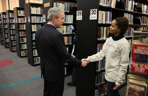President George W. Bush speaks with a volunteer, thanking her for her service, during a visit to the Martin Luther King, Jr., Memorial Library Monday, Jan. 21, 2008 in Washington, D.C., to commemorate Martin Luther King, Jr., Day. White House photo by Eric Draper