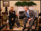 President George W. Bush holds the hand of Elsa Morejon, wife of Presidential Medal of Freedom recipient and human rights activist Oscar Biscet, who is currently being held in a Cuban prison, during a meeting welcoming Morejon to the Oval Office, Thursday, Jan. 24, 2008. White House photo by Eric Draper