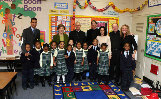 Mrs. Laura Bush accompanied by Archbishop of Washington, D.C.Donald W. Wuerl, pose for a photo with staff and students of Holy Redeemer School Wednesday, Jan. 30.2008, in Washington, D.C. White House photo by Shealah Craighead