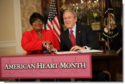President George W. Bush shakes the hand of Joyce Cullen, a heart disease survivor, after signing the Presidential Proclamation in Honor of American Heart Month Friday, Feb. 1, 2008, in Kansas City, Mo. In signing the proclamation, the President thanked Mrs. Cullen for her work and said, ".She's very much a part of the Heart Truth Campaign here in Kansas City. And she's helping people understand two things -- one, be able to recognize the symptoms, and secondly, be able to prevent the symptoms from happening in the first place. So I want to thank you for being a strong leader in the campaign for awareness."  White House photo by Eric Draper