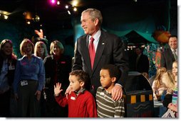 President George W. Bush pauses to talk Friday, Feb. 1, 2008, with Eli Lockhart, left, and Alex Harris, both 6 years old, at the Kaleidoscope Creative Center at Hallmark Cards, Inc., in Kansas City, Mo.  White House photo by Eric Draper