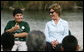 Mrs. Laura Bush smiles as a Florida City Elementary School student gives a thumbs-up while sitting on stage with Mrs. Bush, Wednesday, Feb. 6, 2008, during the Junior Ranger "First Bloom" planting event in Everglades National Park, Fla. Mrs. Bush praised the Everglades restoration program which will help bring back native trees in areas of the Everglades overgrown with non-native plants. White House photo by Shealah Craighead