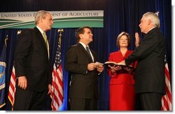 President George W. Bush listens as the Oath of Office is administered ceremoniously by Deputy Secretary Chuck Conner to U.S. Department of Agriculture Secretary Ed Schafer Tuesday, Feb. 6, 2008. Holding the Bible is Nancy Schafer, wife of the new secretary.  White House photo by Chris Greenberg
