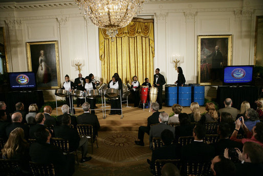 President George W. Bush and Mrs. Laura Bush watch as the St. Veronicas Youth Steel Orchestra performs at the Helping America's Youth Event Thursday Feb. 7, 2008, in the East Room of the White House. White House photo by Shealah Craighead