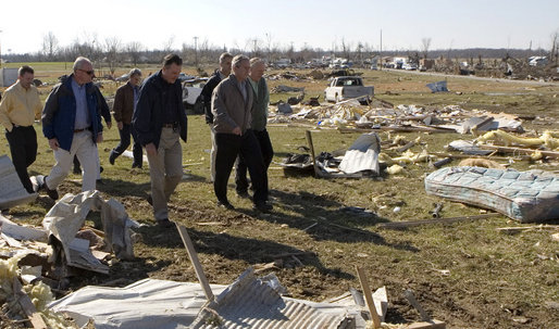 President George W. Bush walks a rubble-strewn stretch of highway in Lafayette, Tennessee Friday, Feb. 8, 2008, during his visit to the region that was hard hit by tornadoes earlier in the week. White House photo by Chris Greenberg