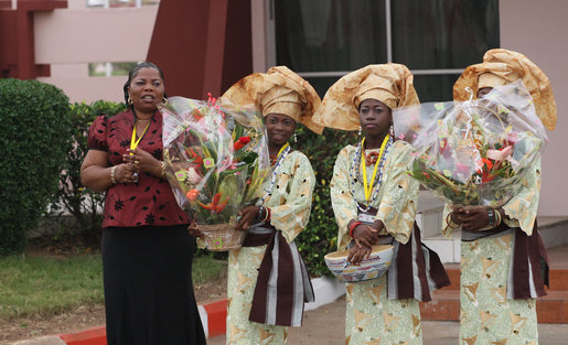Flower girls await the arrival Saturday, Feb. 16, 2008, of President George W. Bush and Mrs. Laura Bush at Cadjehoun International Airport in Cotonou, Benin. The President and First Lady made the stop -- the first of their Africa visit – and spent the day before continuing on to Tanzania. White House photo by Shealah Craighead
