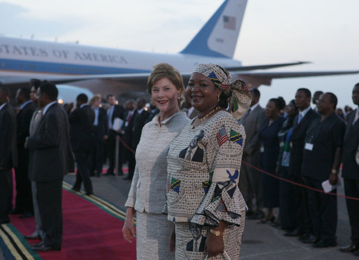 Mrs. Laura Bush and Salma Kikwete, wife of President Jakaya Kikwete of Tanzania, stand on the red carpet Saturday, Feb. 16, 2008, after the arrival of President George W. Bush and Mrs. Bush to Julius Nyerere International Airport in Dar es Salaam. White House photo by Shealah Craighead