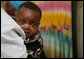 A young Tanzanian child is awed by the camera during a visit by Mrs. Laura Bush Sunday, Feb. 17, 2008, to the WAMA Foundation in Dar es Salaam. The foundation is a non-profit organization founded by Salma Kikwete, First Lady of Tanzania, with a focus on development by improving women’s social and economic status by redefining gender roles and creating more opportunities for the development of women and children. White House photo by Shealah Craighead