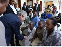 President George W. Bush meets patients and their families Sunday, Feb. 17, 2008, in the reception room of the Amana District Hospital in Dar es Salaam, Tanzania, where President Bush and Mrs. Bush visited a patients and staff at the hospital's care and treament clinic. White House photo by Eric Draper