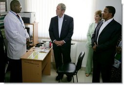 President George W. Bush and Mrs. Laura Bush, joined by Tanzanian President Jakaya Kikwete, visit with a staff doctor Sunday, Feb. 17, 2008, at the Amana District Hospital in Dar es Salaam, Tanzania, where President Bush and Mrs. Bush visited a patients and staff at the hospital's care and treament clinic. White House photo by Chris Greenberg